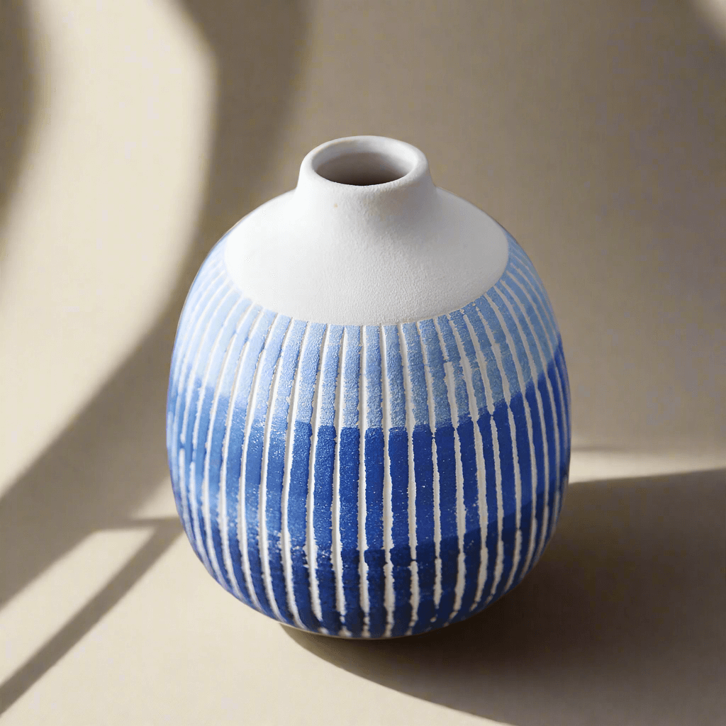 Blue and white textured ceramic bud vase with a rounded shape, perfect for single floral stems or minimalist decor.