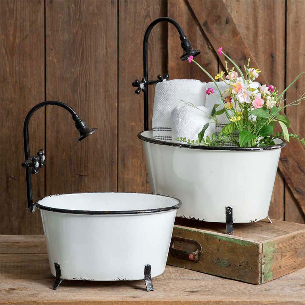 Set of 2 vintage-inspired antique bathtub storage containers with decorative faucet and flowers.