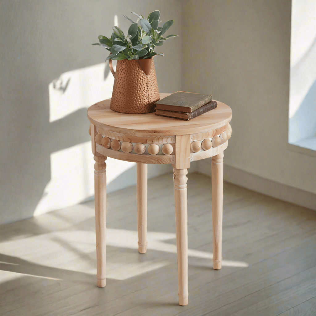 Round Boho side table with natural wood finish, adorned with decorative beads, featuring a potted plant and books on top.