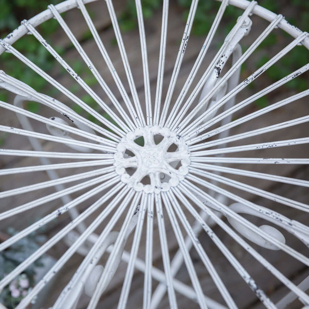 Rustic white metal side table showcasing unique wire design and distressed finish, perfect for vintage-style decor.