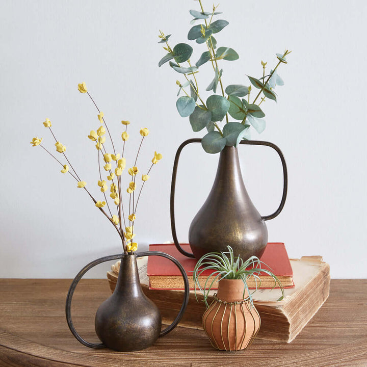 Antique Bronze Boho Vases with flowers on a wooden table, showcasing rustic charm and vintage style.