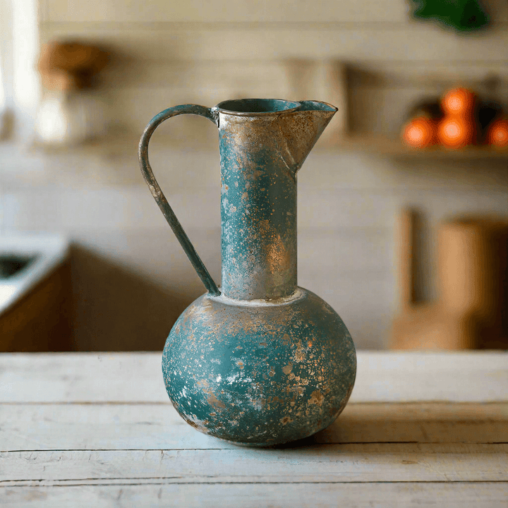 Antique oxidized metal pitcher with a patina finish, adding rustic charm to any vintage decor.