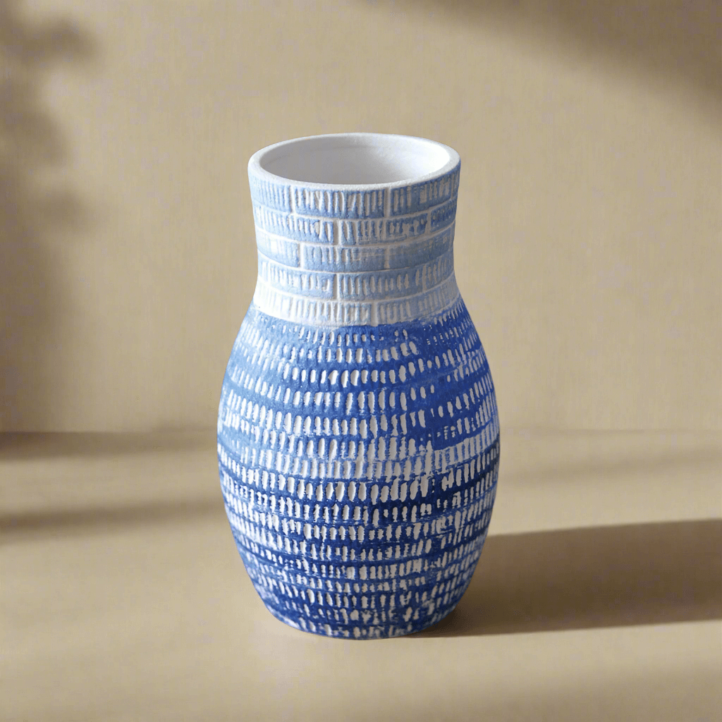 Blue and white textured ceramic vase with artisanal design, perfect for home decor and stylish centerpiece.