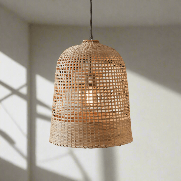 Handwoven grass pendant lamp with a natural texture, illuminating a bright space with bohemian charm.