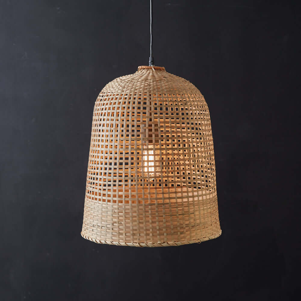 Bohemian handwoven grass pendant lamp showcasing intricate craftsmanship and inviting warm light.