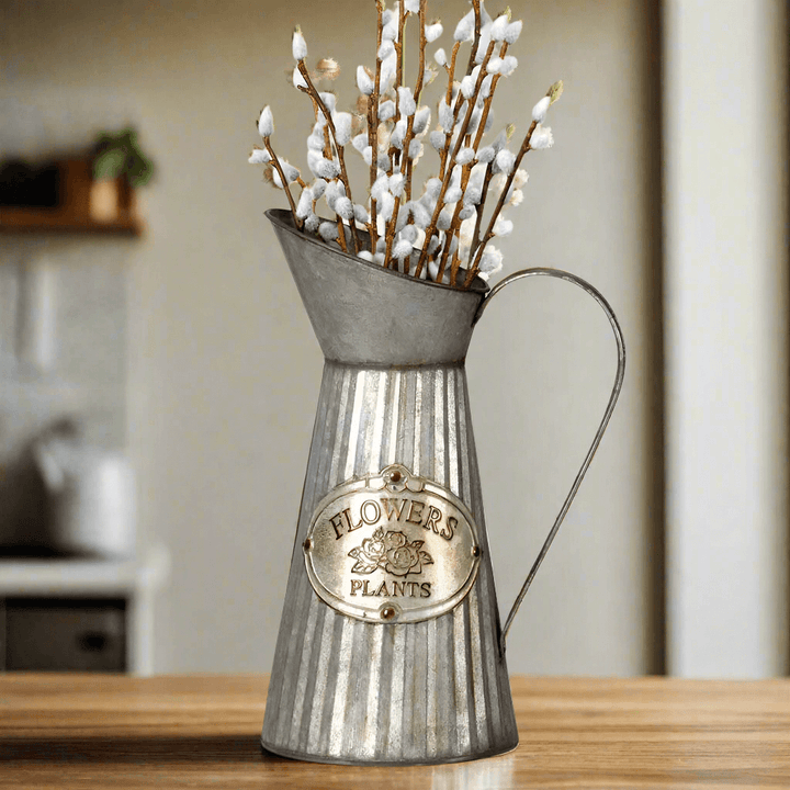 Farmhouse metal pitcher vase with "Flowers" and "Plants" label, featuring decorative branches for rustic home decor.