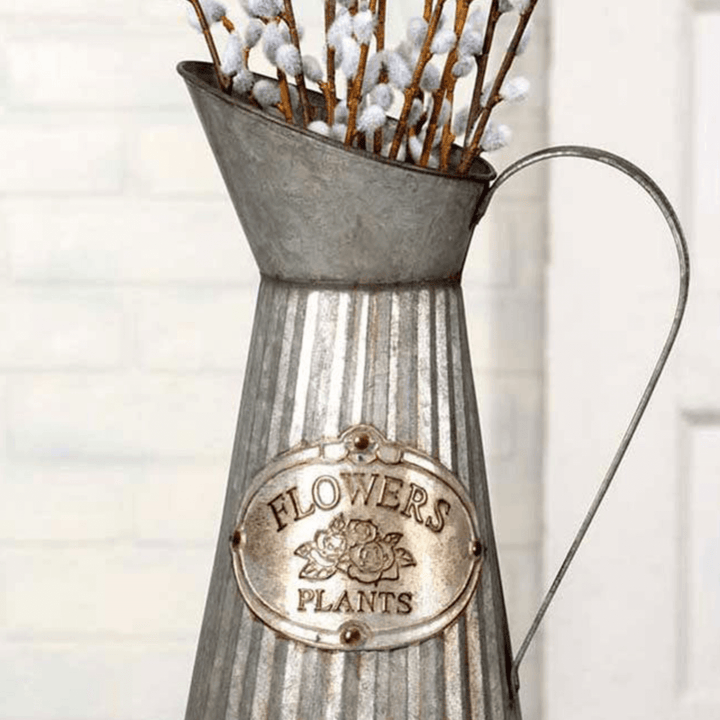 Farmhouse metal pitcher vase with embossed label "Flowers" and "Plants," featuring a rustic corrugated design.