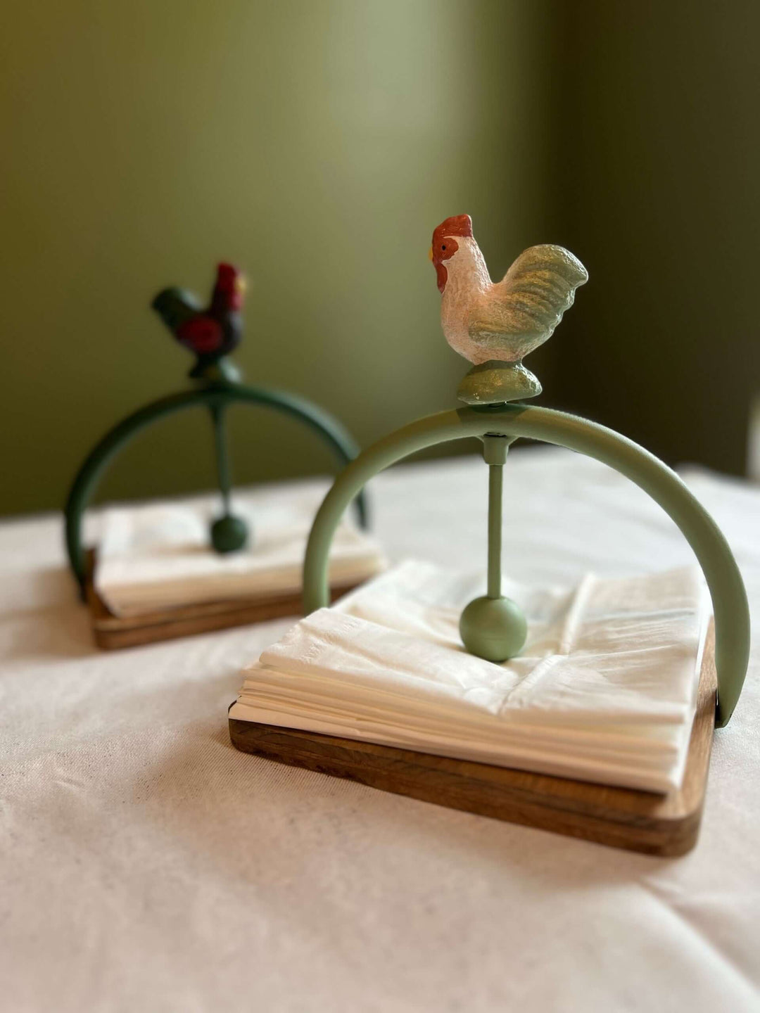 Farmhouse rooster napkin holder with rustic design and sturdy wooden base, ideal for kitchen or dining decor.