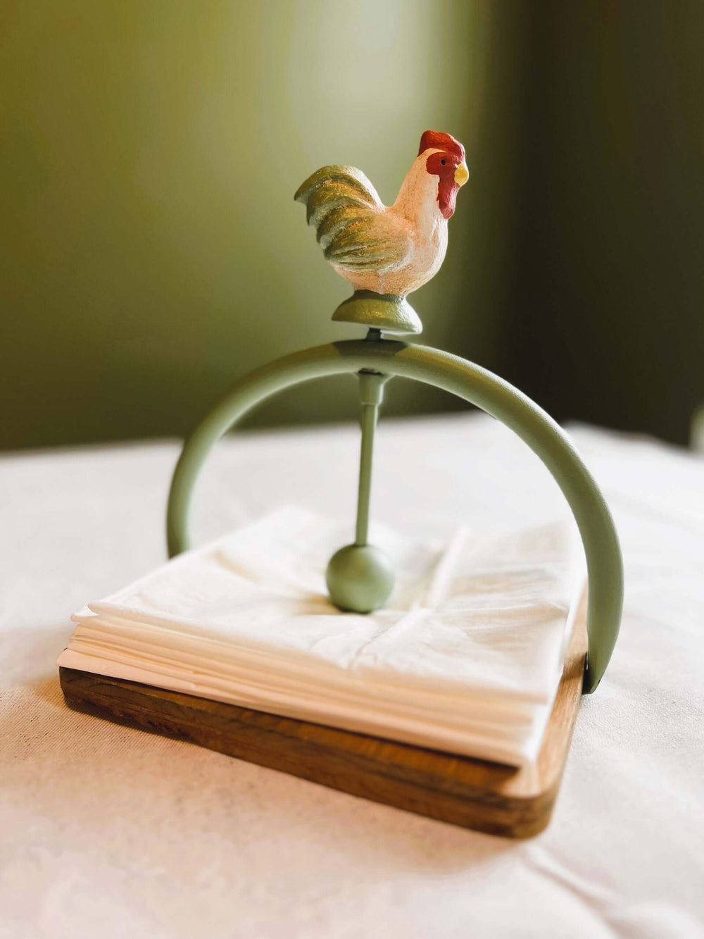 Farmhouse Rooster Napkin Holder with wooden base and metal arch, adding rustic charm to your dining space.