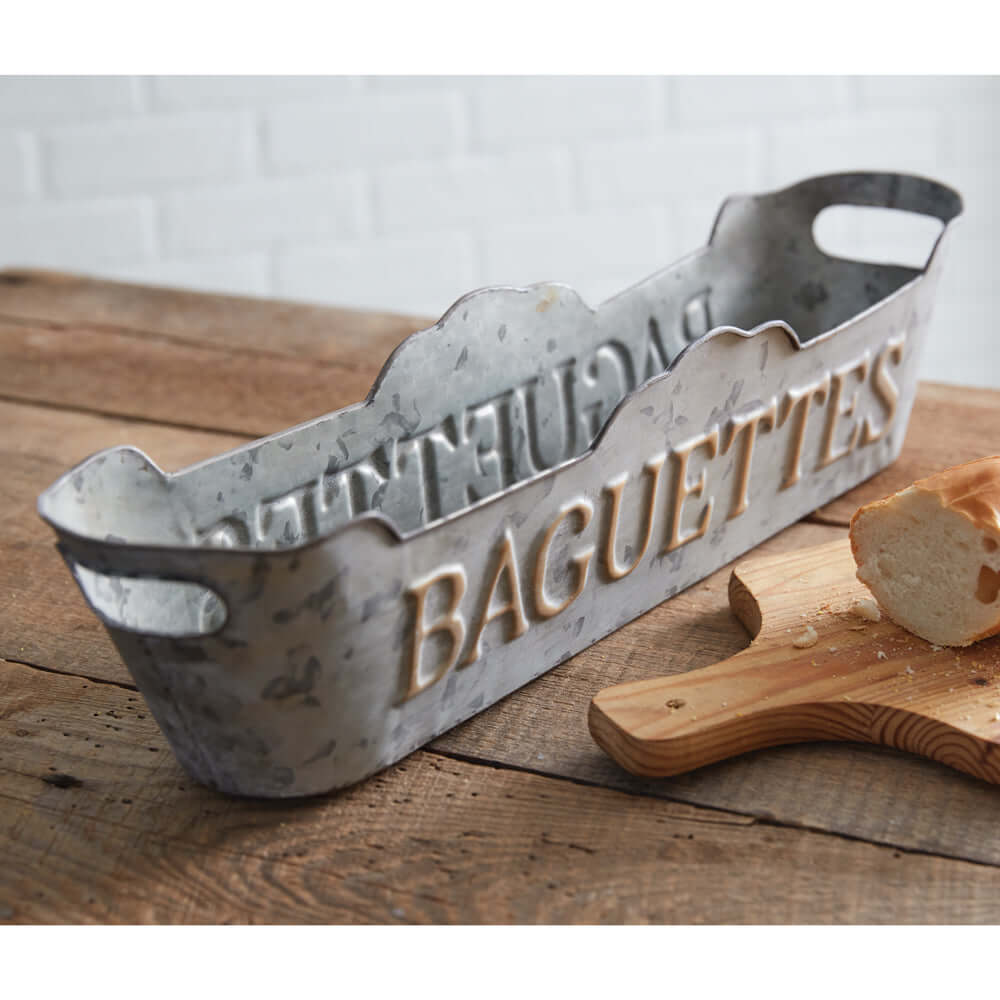 Vintage galvanized metal bread tray engraved "BAGUETTES," perfect for displaying bread and pastries in a rustic kitchen.