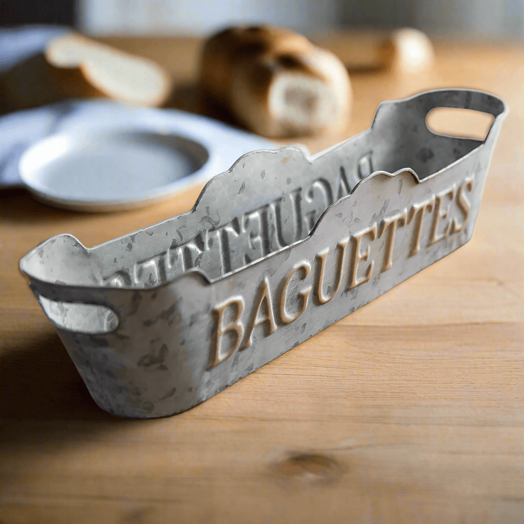 Rustic metal baguette tray with vintage design, perfect for displaying bread in a French country kitchen.