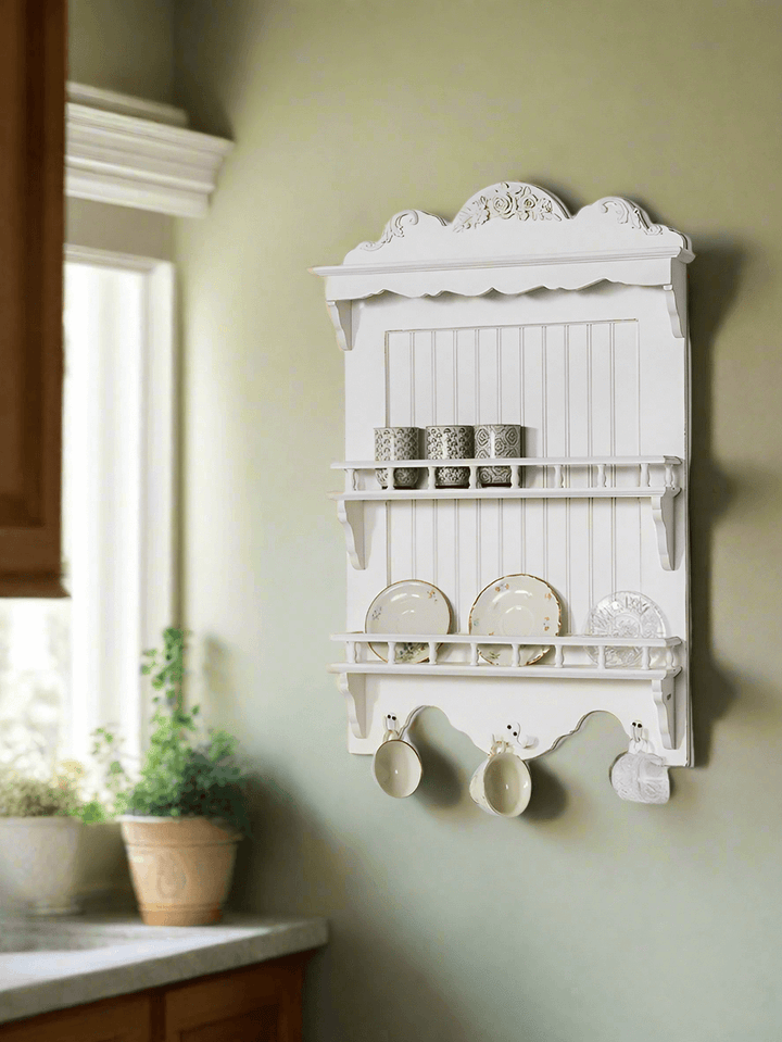 French Country wall-mounted dish rack showcasing elegant white design and decorative detailing in a rustic kitchen setting.