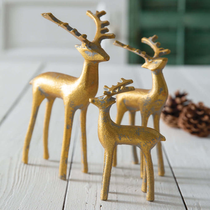 Gold reindeer figurines set of 3, elegant seasonal decorations with intricate details and a warm finish.