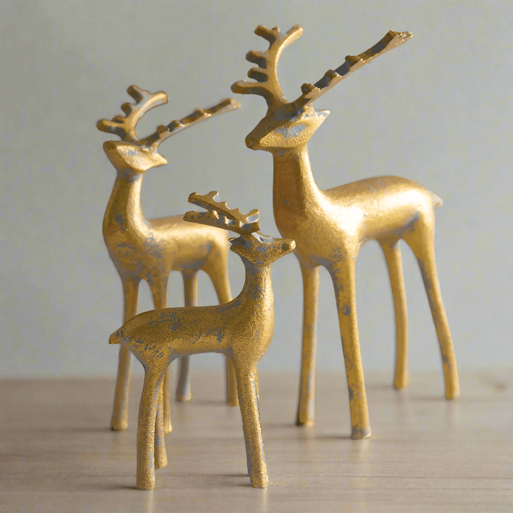 Set of 3 gold reindeer figurines, elegantly crafted for holiday decor, showcasing intricate details and a gleaming finish.