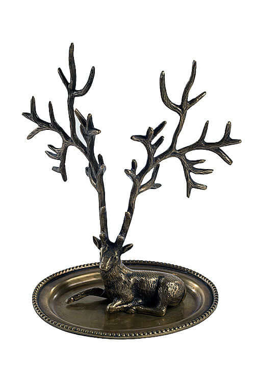 Antique brass deer jewelry holder with elegant antlers for organizing accessories on a vanity or dresser.