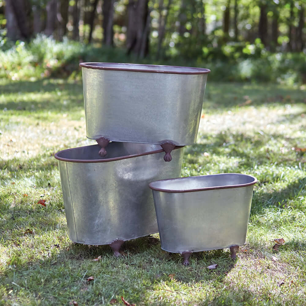 Rustic galvanized metal clawfoot planters set of 3 on grass, perfect for garden decor and plant display.