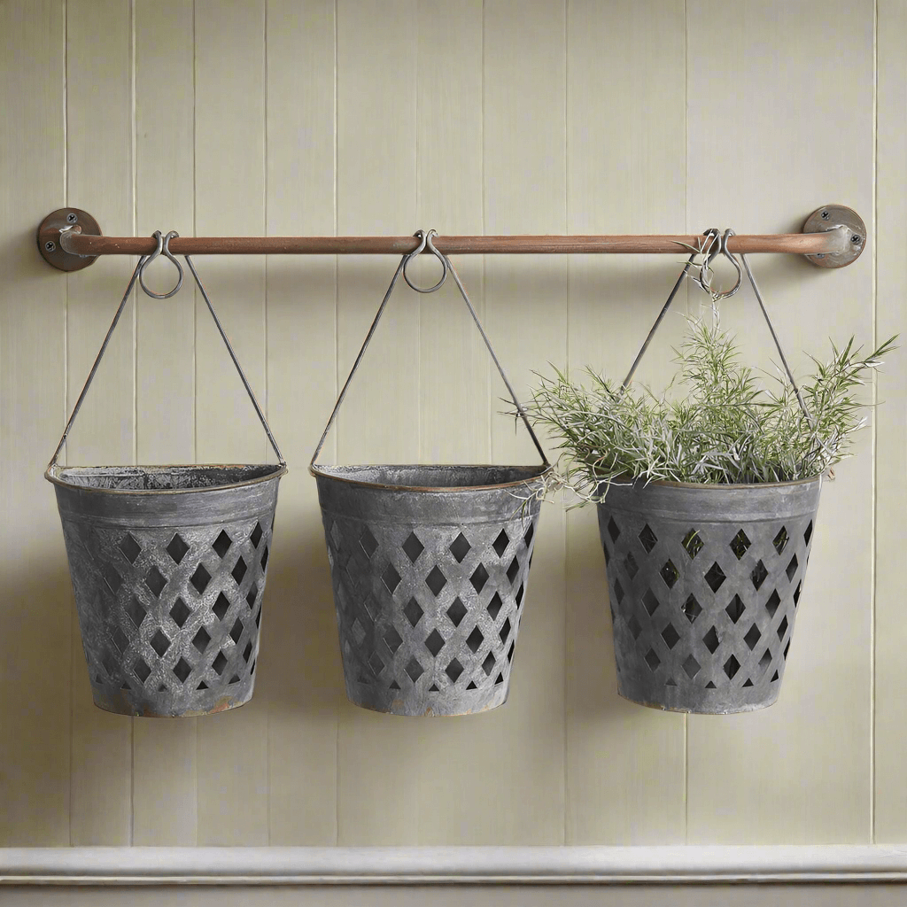 Rustic hanging lattice basket planters on a wall, showcasing potted greenery in galvanized metal containers.