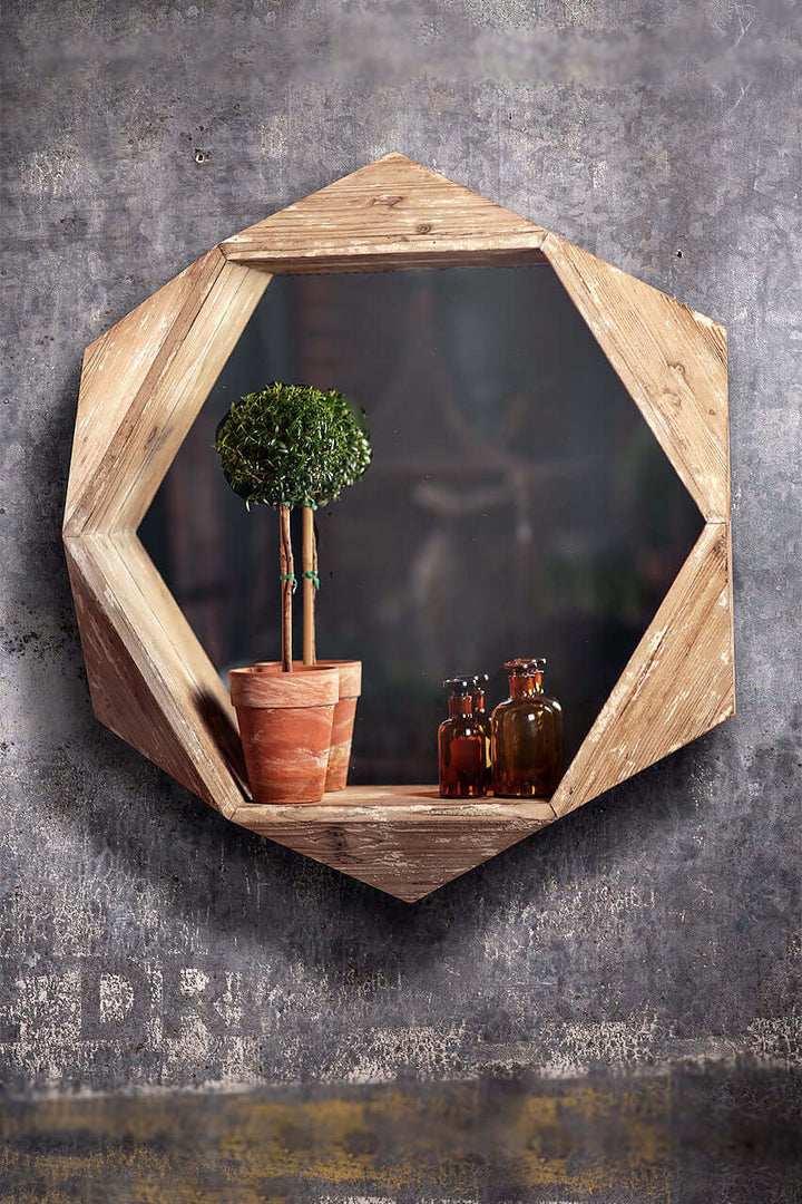 Rustic hexagonal wood wall mirror featuring a wooden frame and decorative elements like potted plants and bottles.