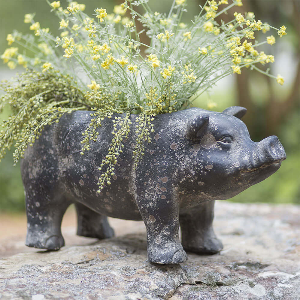 Rustic Pig Planter with yellow flowers, crafted from resin for an elegant garden or home decor touch.