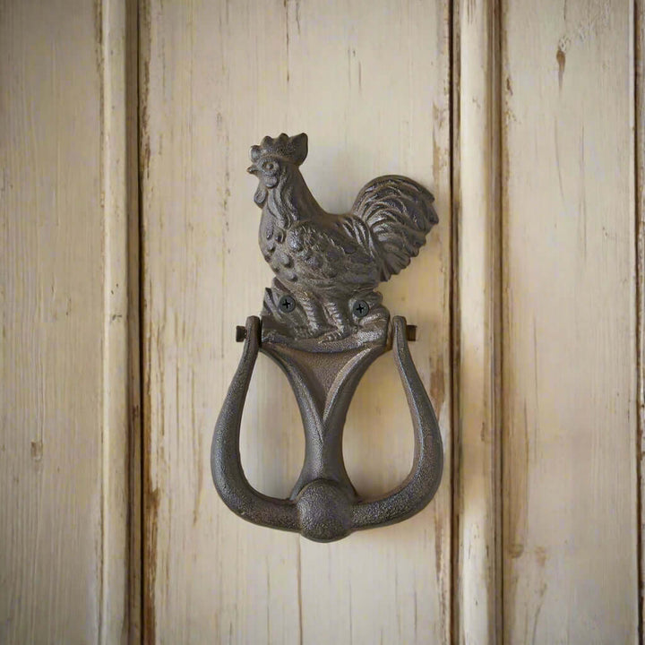 Rustic rooster door knocker made of cast iron, adding farmhouse charm to any entryway decor. Set of 2 for stylish functionality.