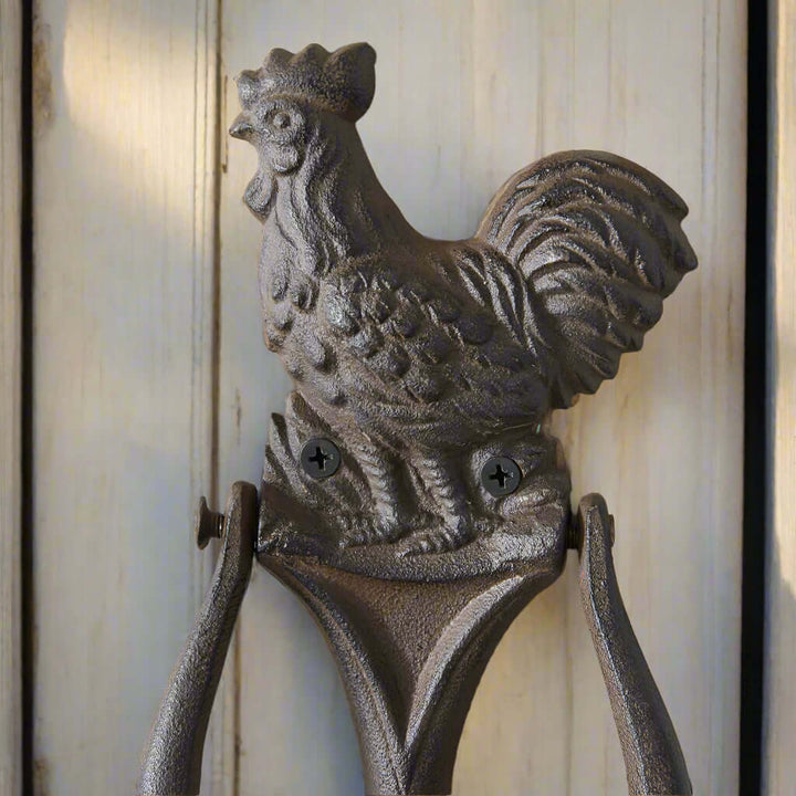 Rustic rooster door knocker in cast iron design, adding farmhouse charm to your entryway. Perfect for welcoming guests.