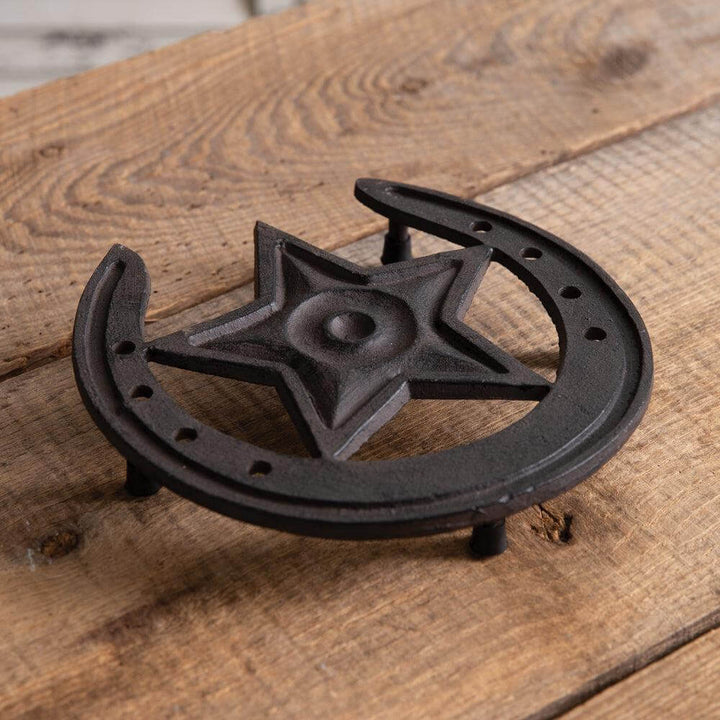 Rustic Western Star Cast Iron Trivet with horseshoe design on wooden surface, perfect for farmhouse kitchens.