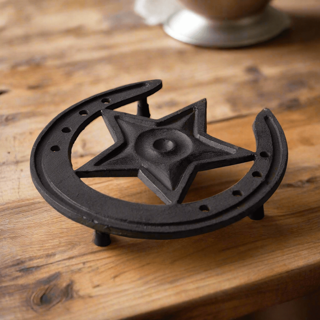 Rustic Western Star Cast Iron Trivet with horseshoe design on a wooden table, perfect for farmhouse decor.