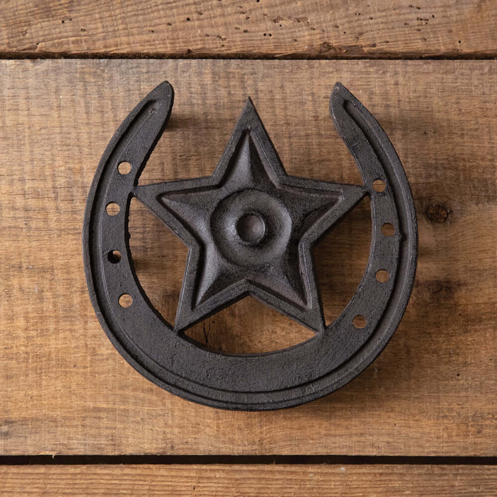 Rustic Western Star Cast Iron Trivet with horseshoe design on wooden background, ideal for farmhouse decor.