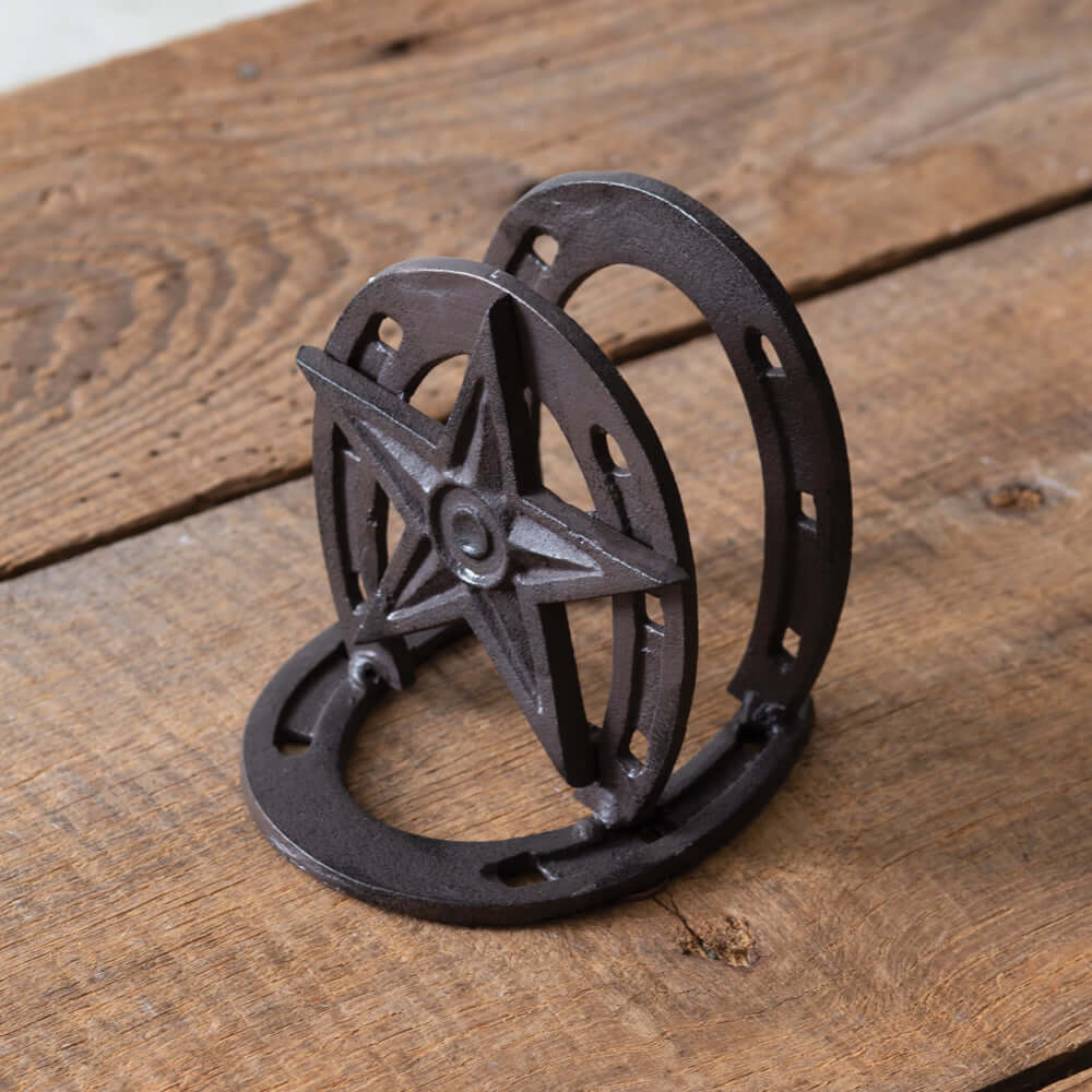 Rustic Western Star Napkin Holder crafted from cast iron, featuring a star and horseshoe design on a wooden table.