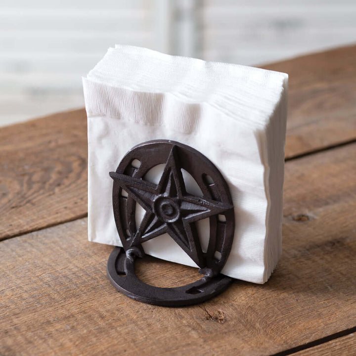 Rustic Western star napkin holder in cast iron, adding country charm to kitchen or dining decor.