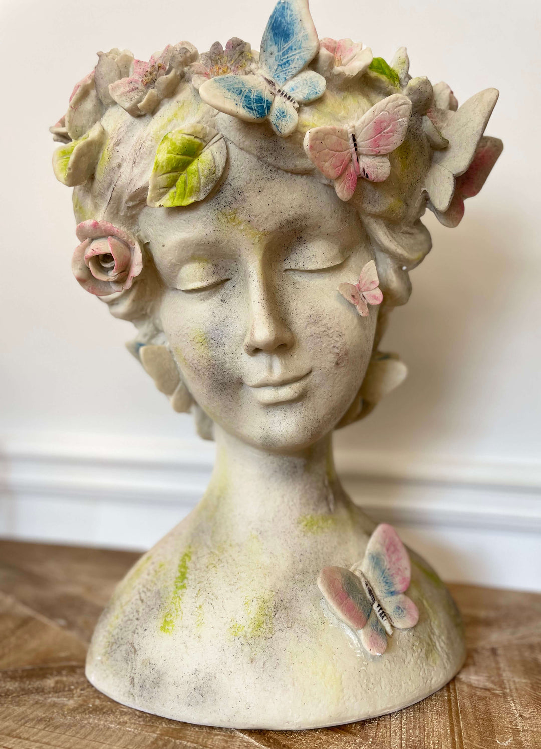 Whimsical butterfly goddess planter bust with colorful butterflies and floral details, perfect for plant display.